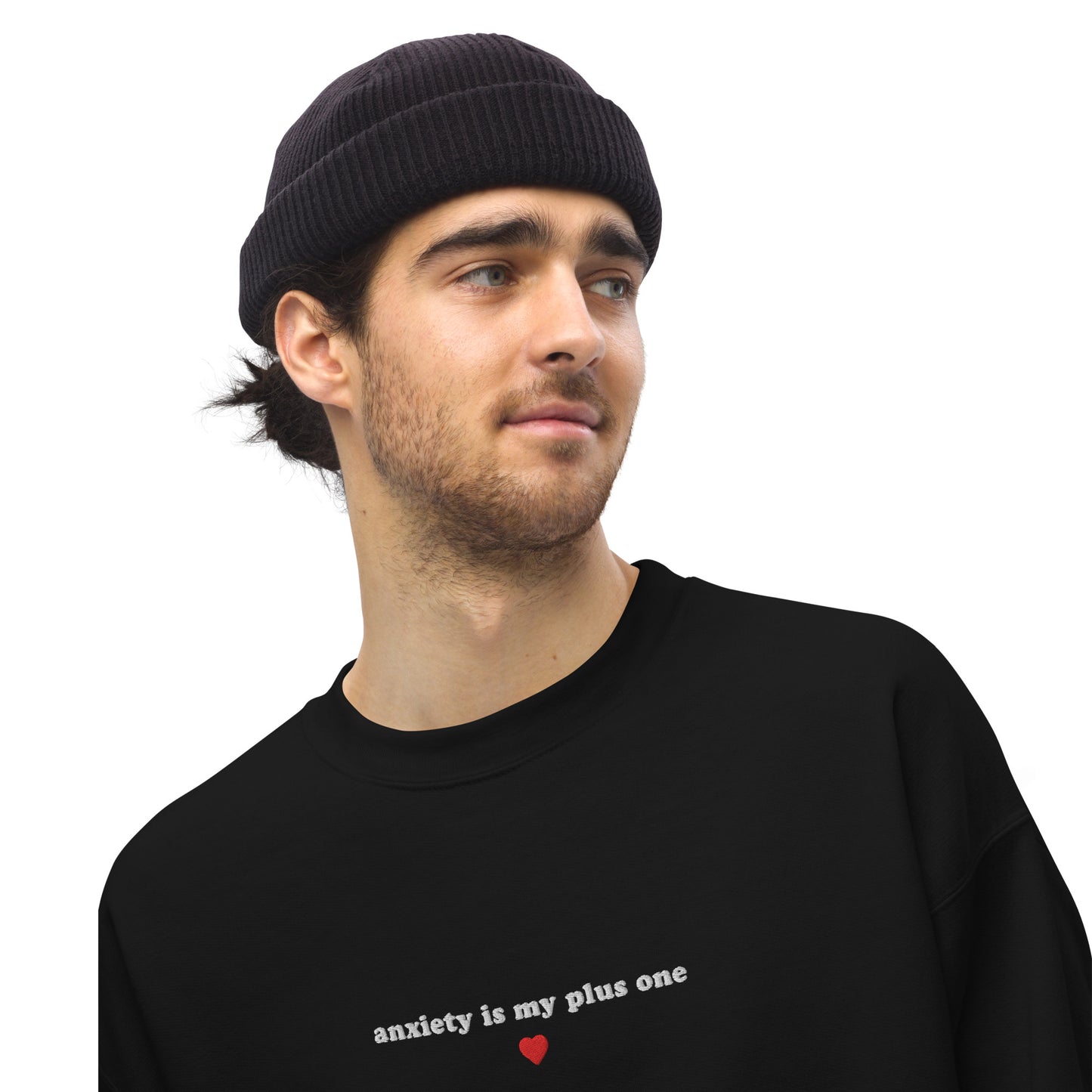 Embroidered unisex sweatshirt saying 'anxiety is my plus one' on a black background, perfect for mental health awareness.