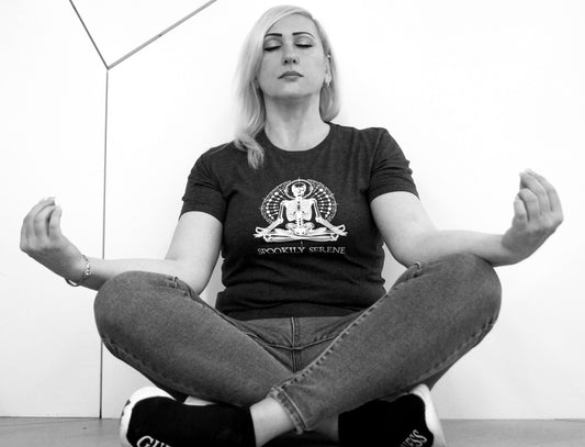 woman wearing spookily serene t-shirt meditating doing yoga