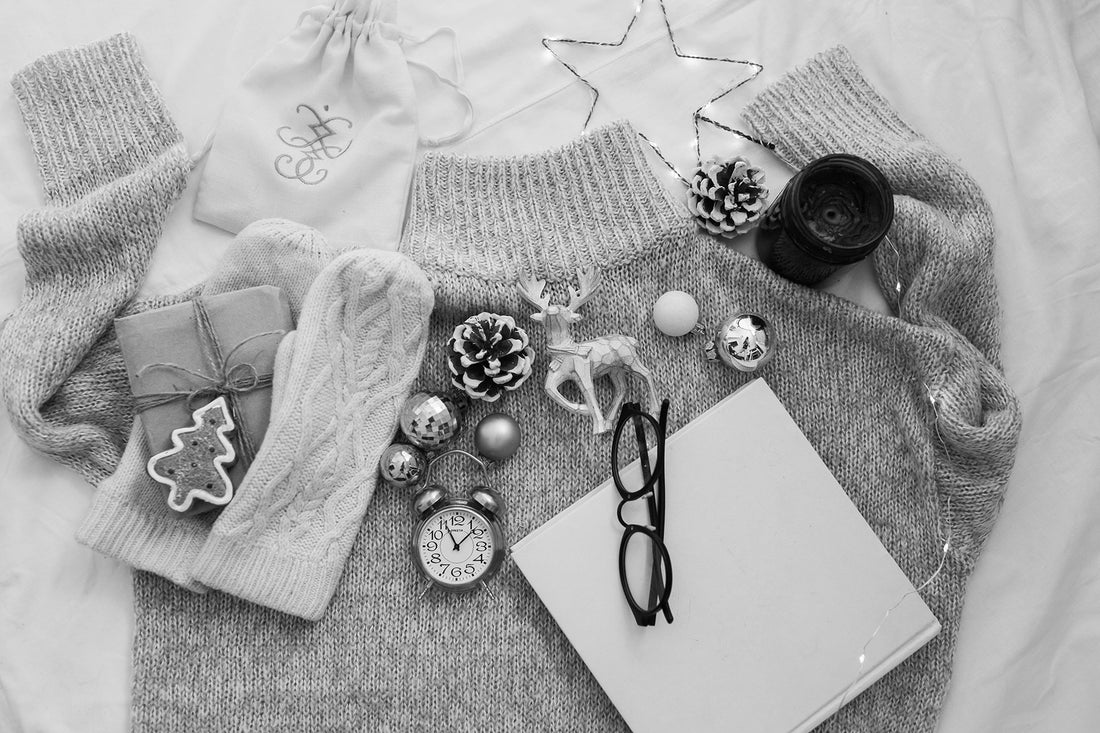 sweatshirt and christmas attributes: stars, candles, gift, mittens, pine cones, glasses, small deer figurine