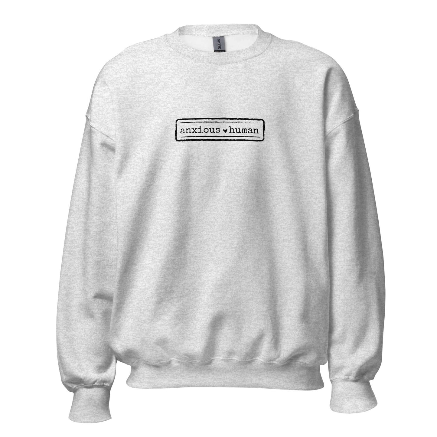 Ash grey unisex sweatshirt featuring 'anxious human' text, promoting mental health awareness and self-expression.