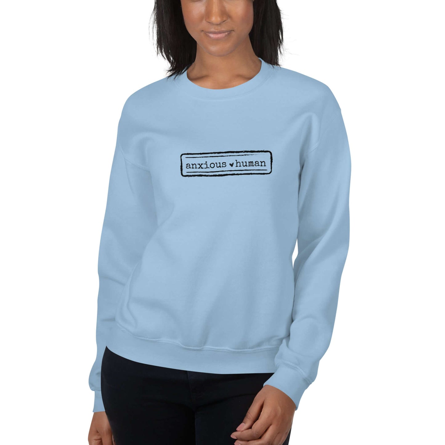 Female Model wearing Anxious Human unisex crewneck in light blue, promoting mental health awareness and self-expression, perfect for gifting.